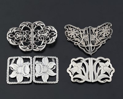 Lot 447 - Four twentieth-century silver buckles, one Art...