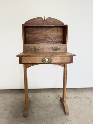 Lot 760 - A small arts and crafts style oak bureau or...