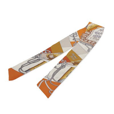 Lot 435 - Hermes, an orange Cliquetis silk Twilly scarf.