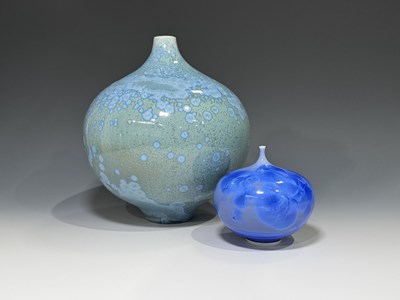 Lot 122 - Two crystaline vases, bulbous footed bottle...