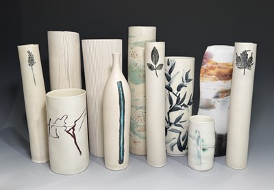 Lot 109 - A collection of white cylindrical vessels,...
