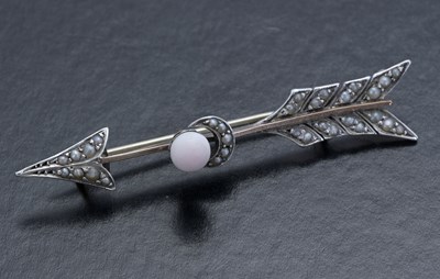 Lot 16 - An early 20th century gold and silver, pink coral and pearl arrow brooch