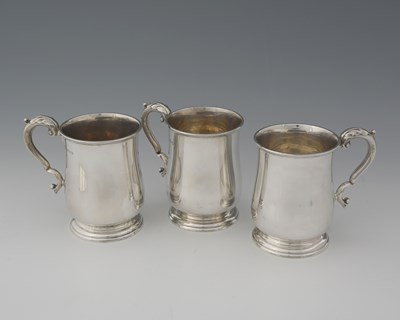 Lot 74 - A set of three George V silver pint mugs, each...