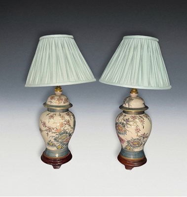 Lot 664 - A pair of ceramic table lamps with blue fabric...