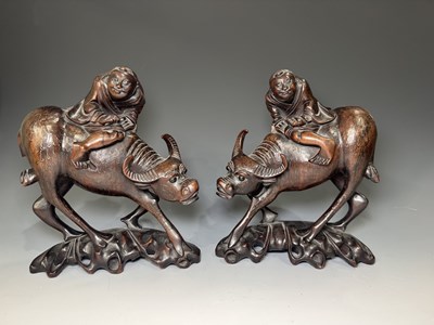 Lot 219 - Pair of Chinese hardwood figures of boys on...