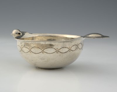 Lot 6 - A silver-coloured metal wine taster, or bowl,...