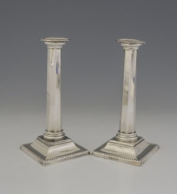 Lot 422 - A pair of George V silver candlesticks, with...