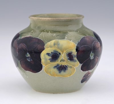 Lot 524 - William Moorcroft, a small Pansy on celadon...