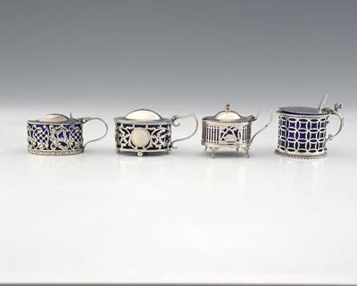 Lot 149 - Four silver mustard pots, each with a pierced...