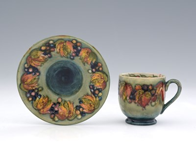 Lot 512 - William Moorcroft, a Leaf and Berry coffee cup...