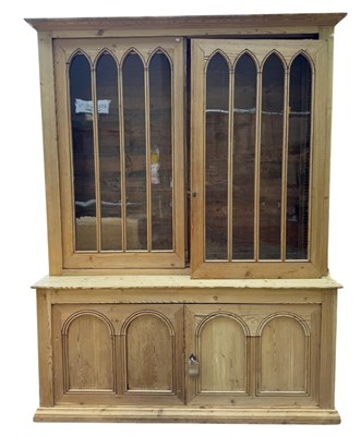 Lot 780 - A large pine glazed-top cupboard or dresser...