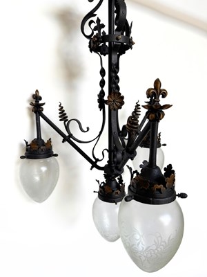 Lot 698 - A blackened wrought metal three-arm, four...