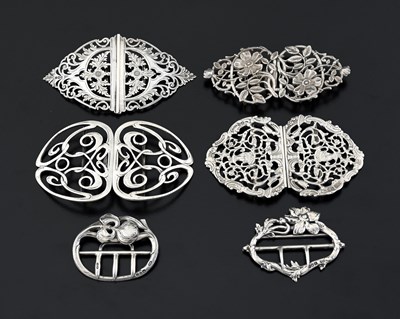 Lot 332 - A group of silver buckles, to include an Art...