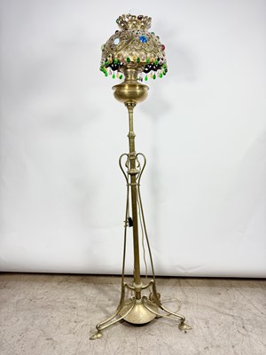Lot 549 - A brass tripod standard lamp in the Art...