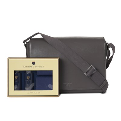 Lot 299 - Aspinal of London, a Reporter messenger bag w/ care kit.