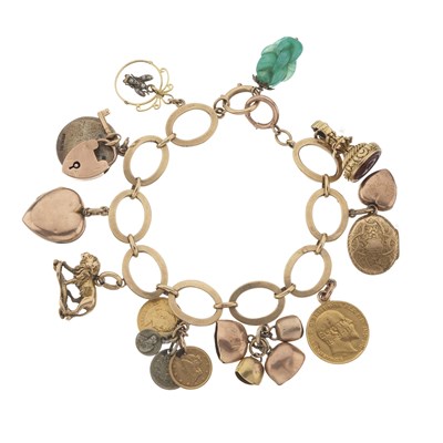 Lot 44 - A 9ct gold charm bracelet, suspending twelve charms