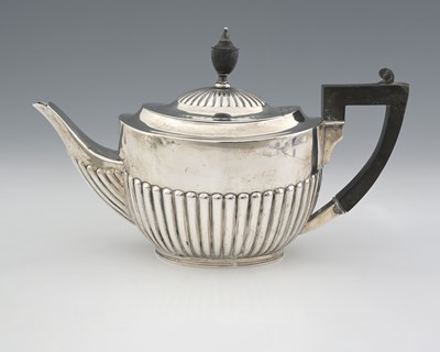 Lot 413 - An Edwardian silver teapot, decorated with...