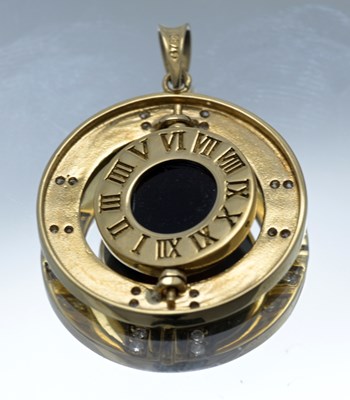 Lot 54 - An 18ct gold onyx and brilliant-cut diamond swivel pendant