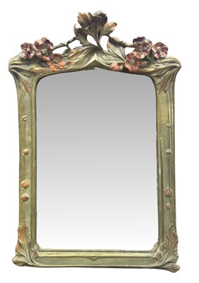 Lot 147 - A large Art Nouveau wall mirror, modelled in...
