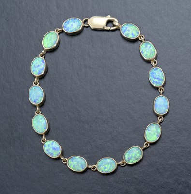 Lot 38 - A 9ct gold synthetic opal line bracelet