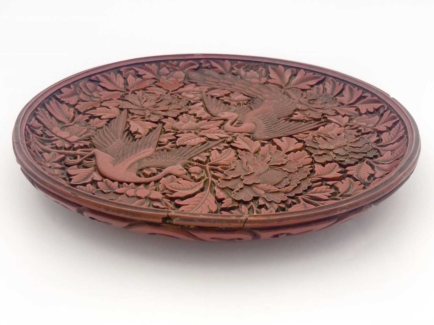 Lot 624 - A Cinnabar carved lacquer circular charger,...