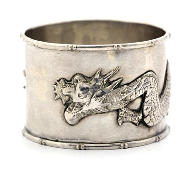 Lot 119 - A Chinese silver napkin ring, cast with a...