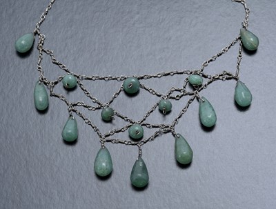 Lot 77 - An Arts and Crafts green jade type bead...