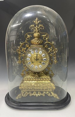 Lot 130 - A Late 19th century brass mantle clock under...