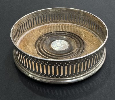 Lot 216 - A silver-mounted bottle coaster, turned wooden...