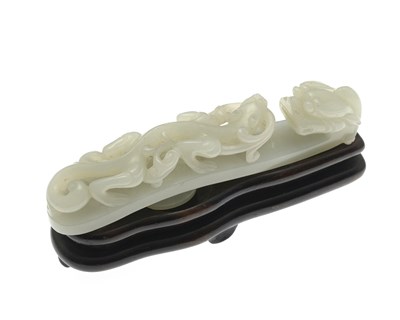 Lot 468 - A Chinese carved jade belt hook, modelled in...