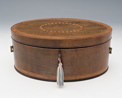 Lot 209 - A George III oval mahogany wig box, circa 1810,...
