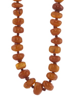 Lot 88 - A graduated natural amber bead necklace