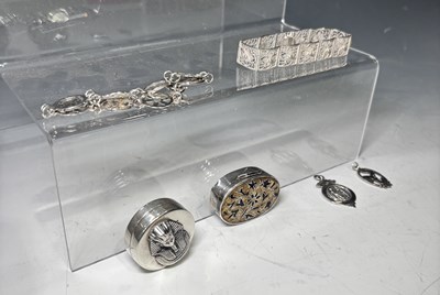 Lot 288 - A white metal pillbox decorated with a relief...