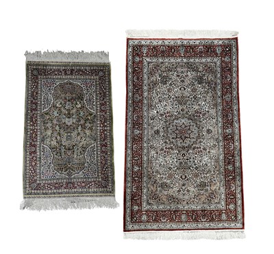 Lot 346 - Two silk rugs, larger on a red ground approx...