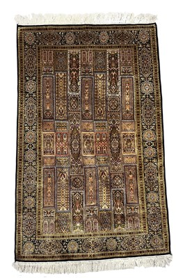Lot 338 - A silk rug in the Qum style, possibly Kashmir,...
