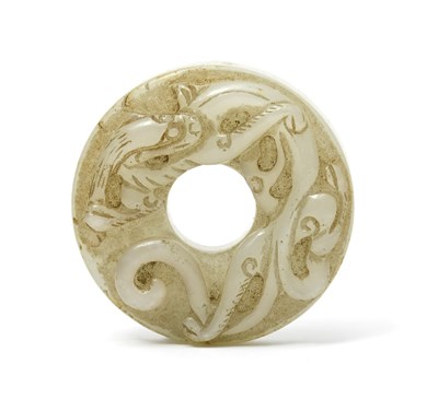 Lot 472 - A Chinese jade Bi disc, carved to one side...