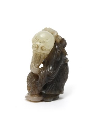 Lot 474 - A Chinese two colour jade carving of a bearded...
