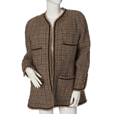 Lot 329 - Chanel, a vintage collarless tweed jacket.