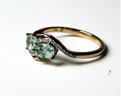 Lot 259 - An 18ct gold tourmaline and diamond crossover dress ring