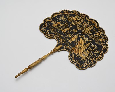 Lot 201 - A Regency black lacquer face screen or fixed...