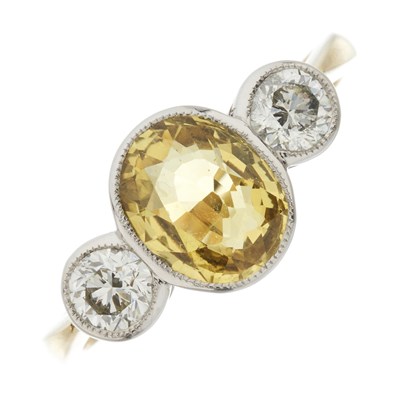 Lot 95 - An 18ct gold and platinum, yellow sapphire and diamond three-stone ring