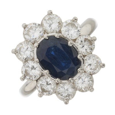 Lot 182 - A platinum sapphire and diamond cluster ring