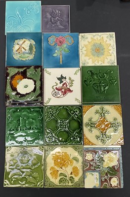 Lot 84 - A collection of relief moulded tiles including...