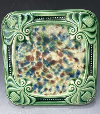 Lot 252 - Carter, Poole, a majolica glazed trivet,...