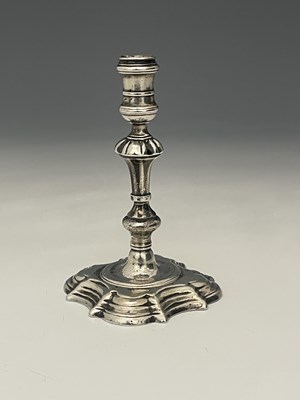 Lot 129 - An eighteenth-century silver cast taperstick,...