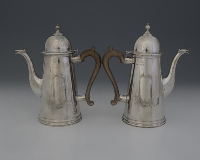 Lot 296 - A pair of George V silver coffee pots, by...