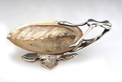 Lot 114 - An Arts and Crafts silver mounted shell dish,...