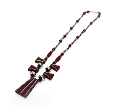 Lot 54 - An Art Deco Odeon burgundy glass necklace, the...