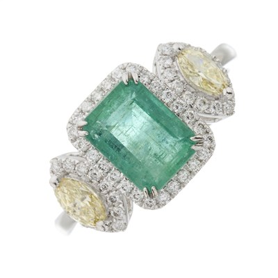 Lot 91 - A platinum emerald, yellow diamond and diamond cluster dress ring