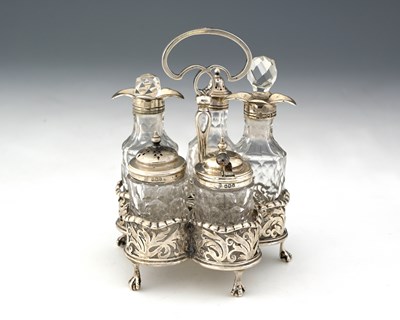 Lot 197 - A George V silver five-bottle condiment set,...